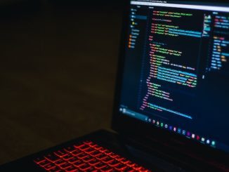 Computer screen with code and keyboard