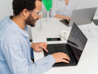 Software tester working on computer at his desk