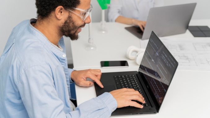 Software tester working on computer at his desk