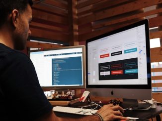software tester testing website with two screens