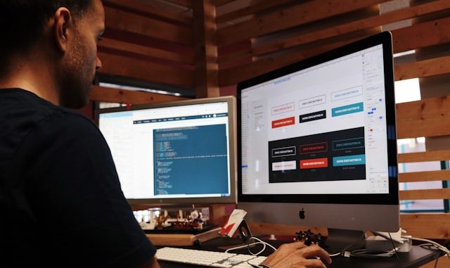 software tester testing website with two screens
