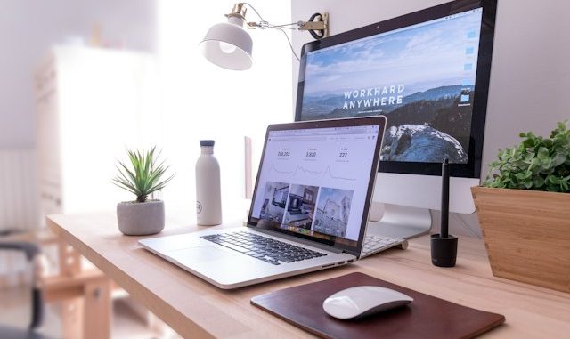 Two computers on office desk with ecommerce website screens